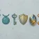 Six game item icons laid out side by side on a pale gray surface, where the outline thickness, tint and light direction visibly drift from one to the next, and one icon is glossy and realistic while